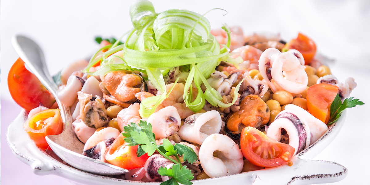 Mixed salad with com crisp and flavored mayonnaise served in glass 