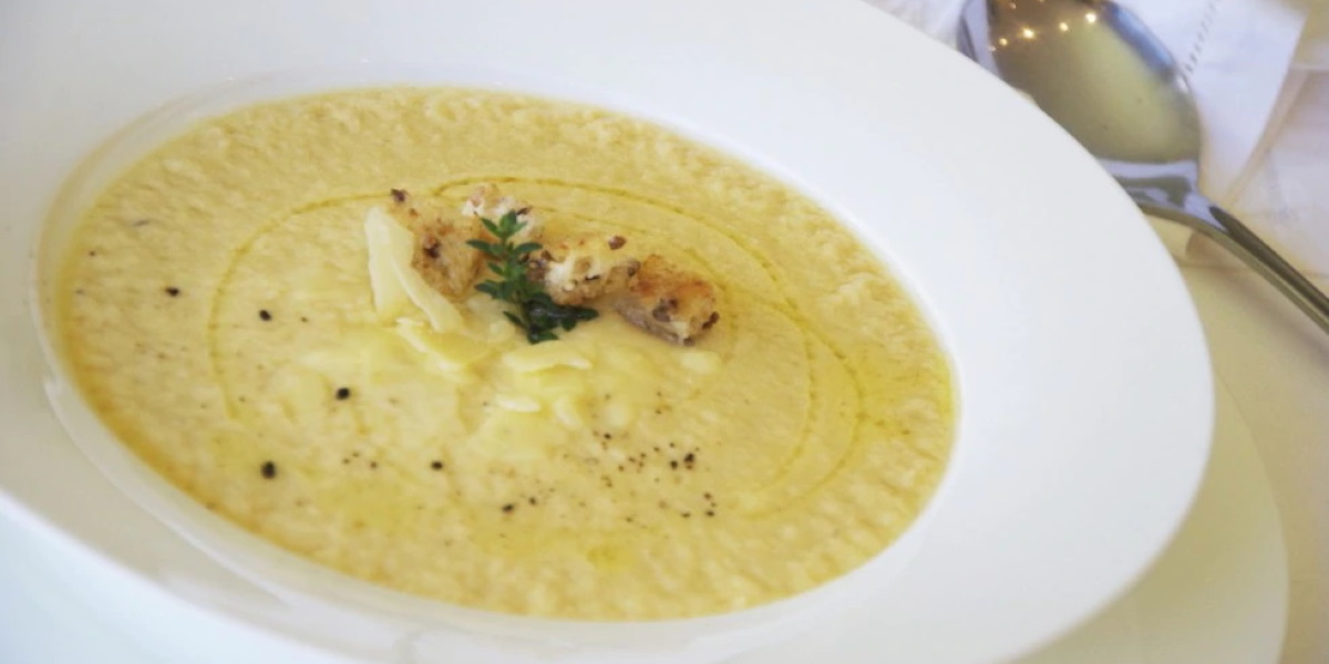 Chicken cream soup with almonds and crispy bread croutons